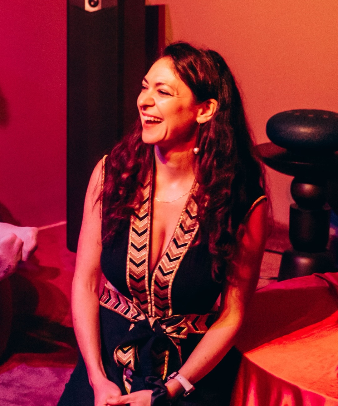 Lucy Diamond, kneeling by the ritual table, laughing